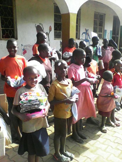Classic the picture of the children receiving clothing sent from the container