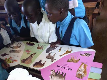 Classic tegot children reading a book left to right lamwaka patricia prossy apiyo and akello jacklyn after saturday club