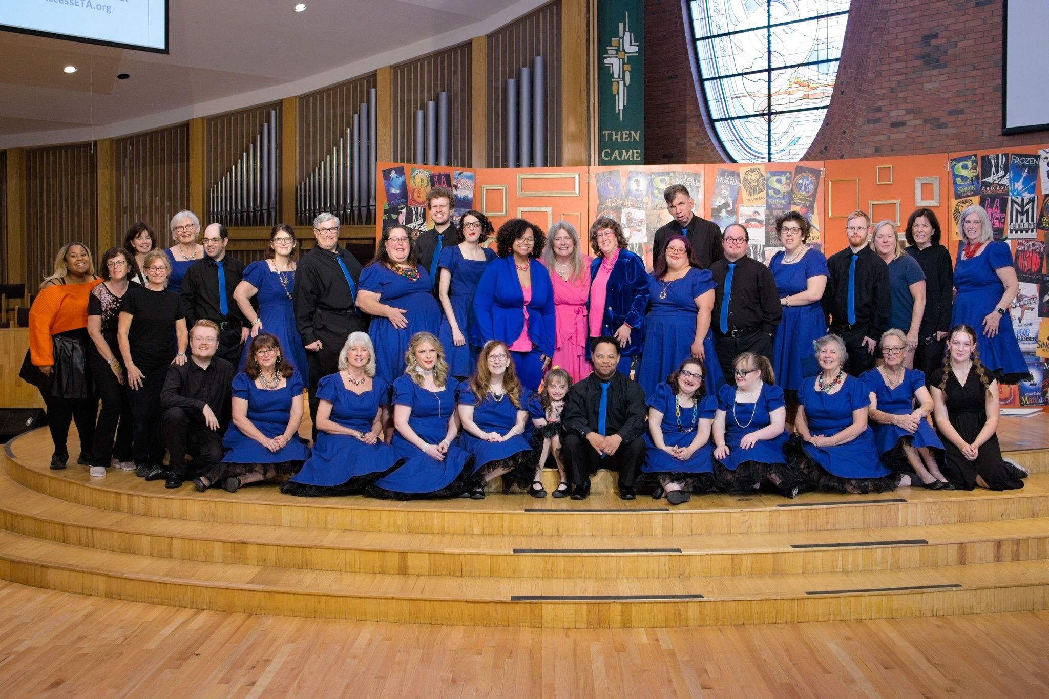 The cast of ETA's Courageous Cabaret pose together with smiles. November 2023